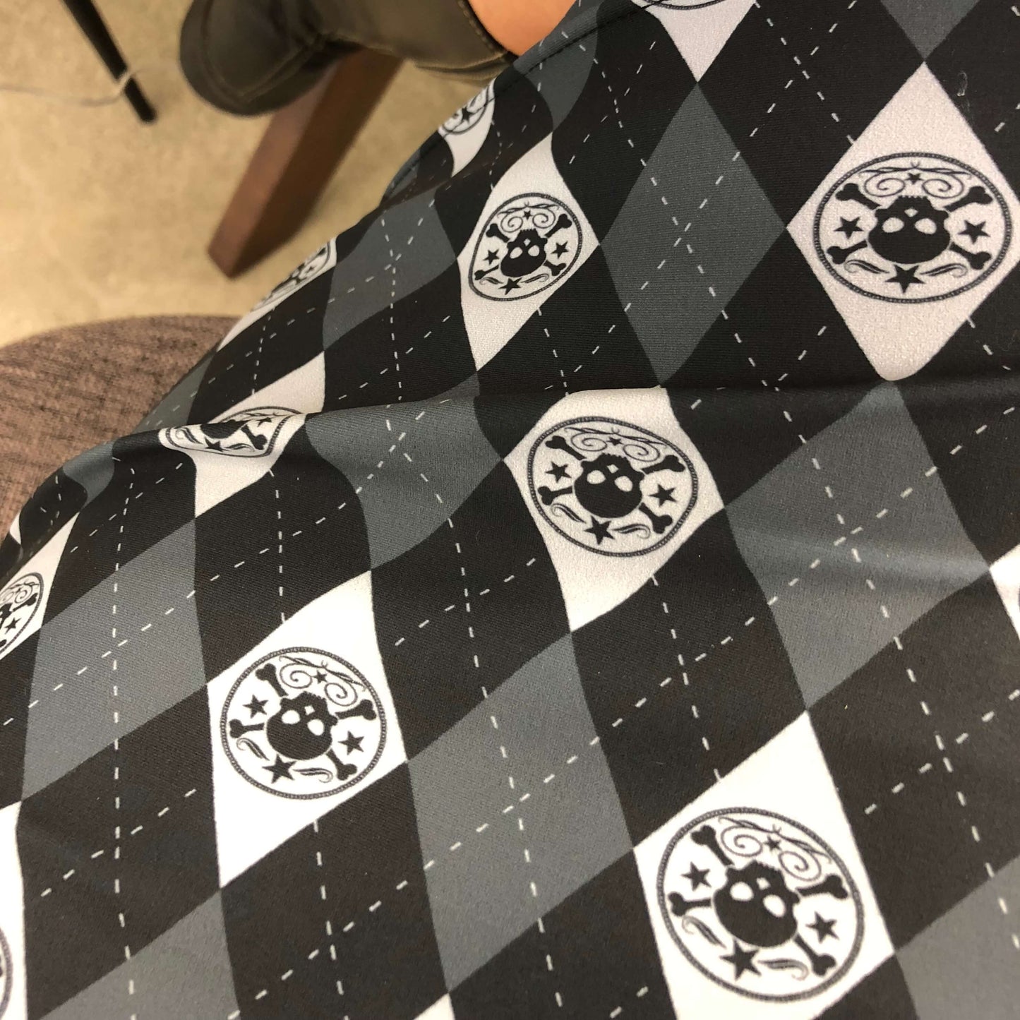 Close up of black white and grey skull print on pencil skirt