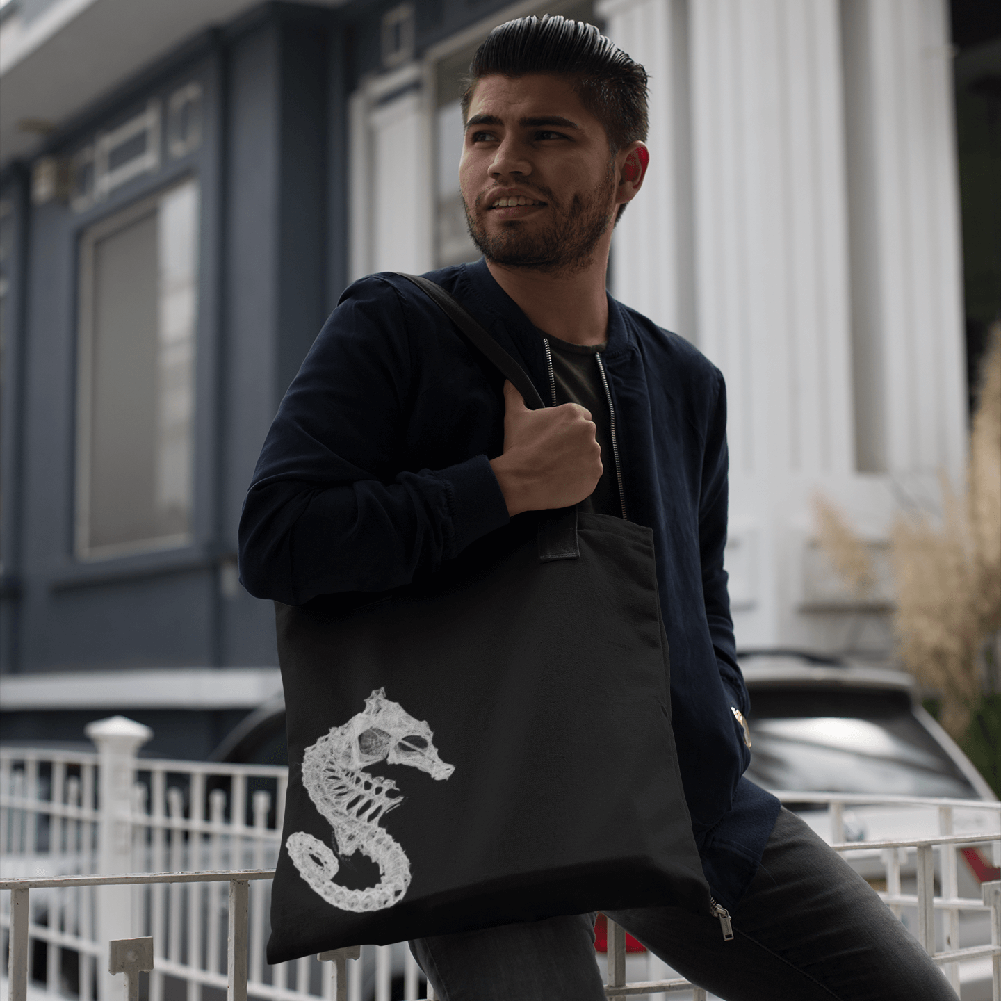 Man carrying reusable cloth tote with seahorse skeleton