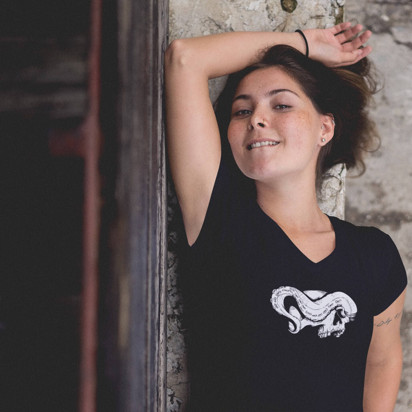 Woman wearing black v-neck skull print shirt with tentacle
