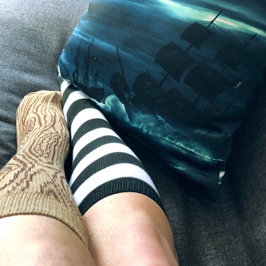 Peg leg socks with pirate ship throw pillow