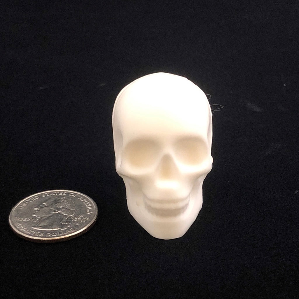 Single skull soap next to a quarter for size