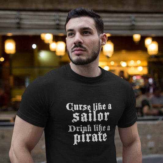 Dark haired man wearing curse like a sailor drink like a pirate tee shirt