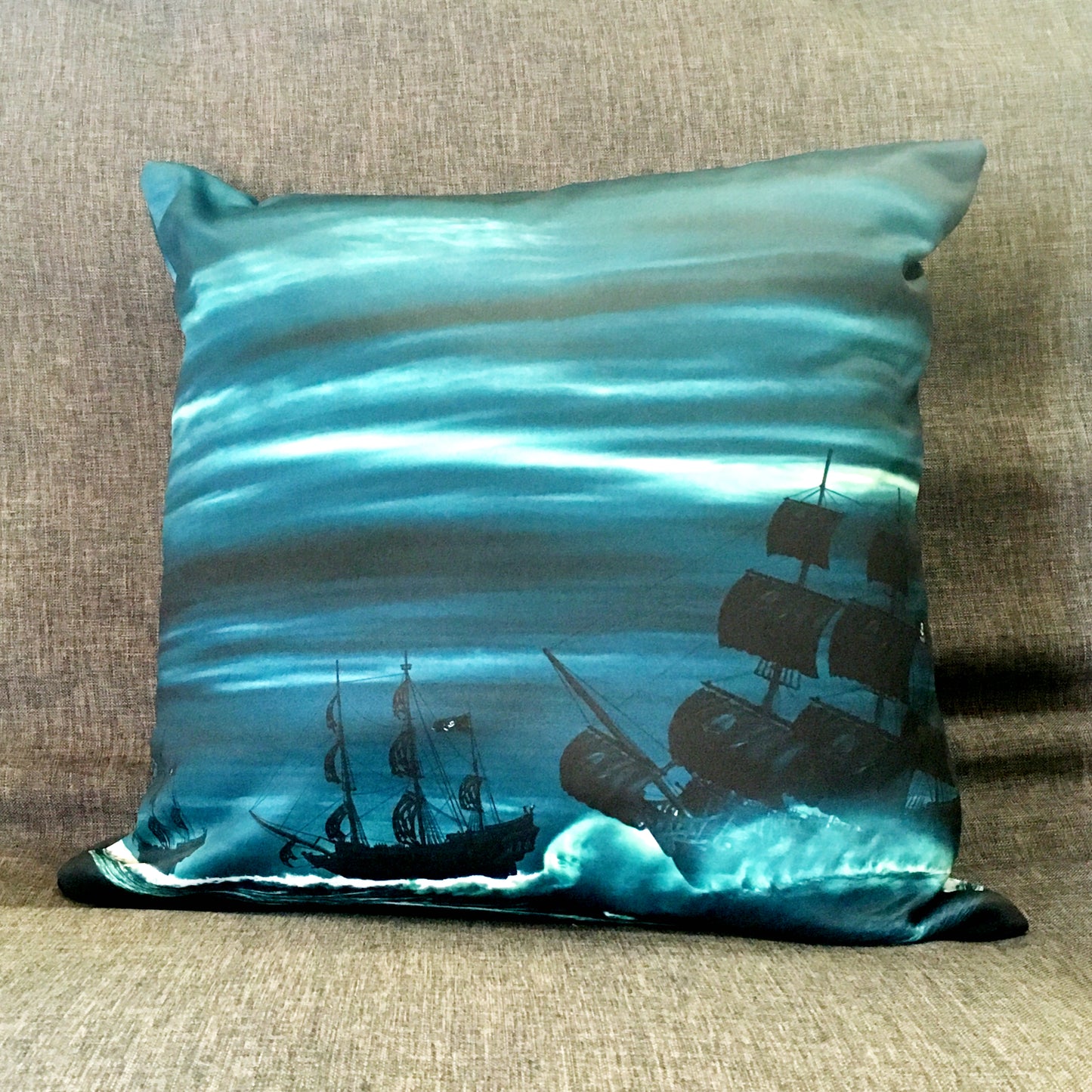 Blue, white, and black pirate ships on a square throw pillow