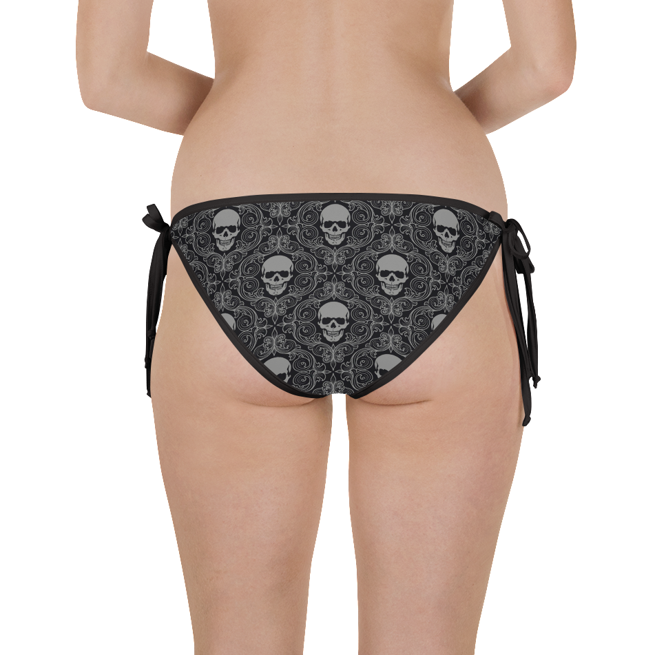 Woman facing away from camera wearing skeleton wallpaper bikini bottom