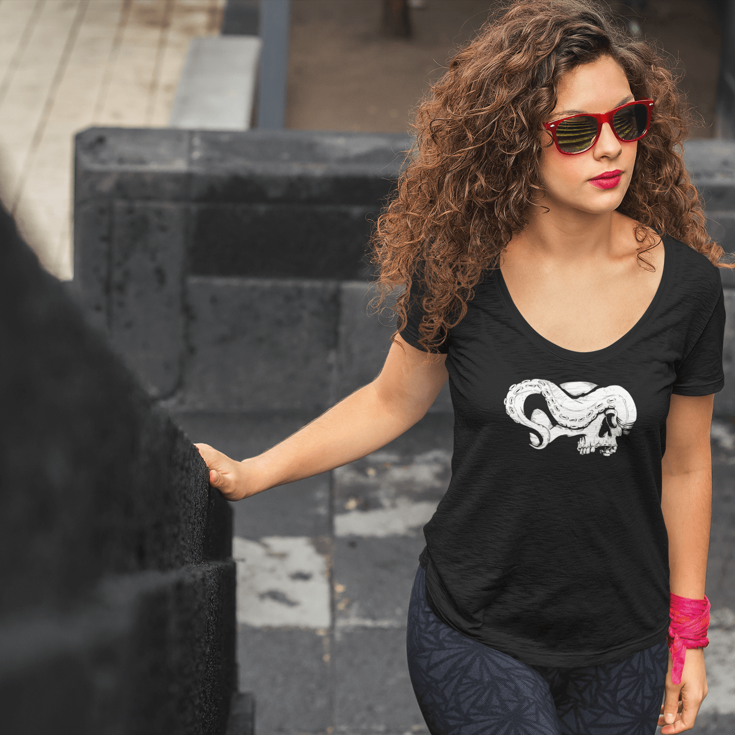 Woman with long hair wearing a black scoop neck shirt with skull and tentacle print