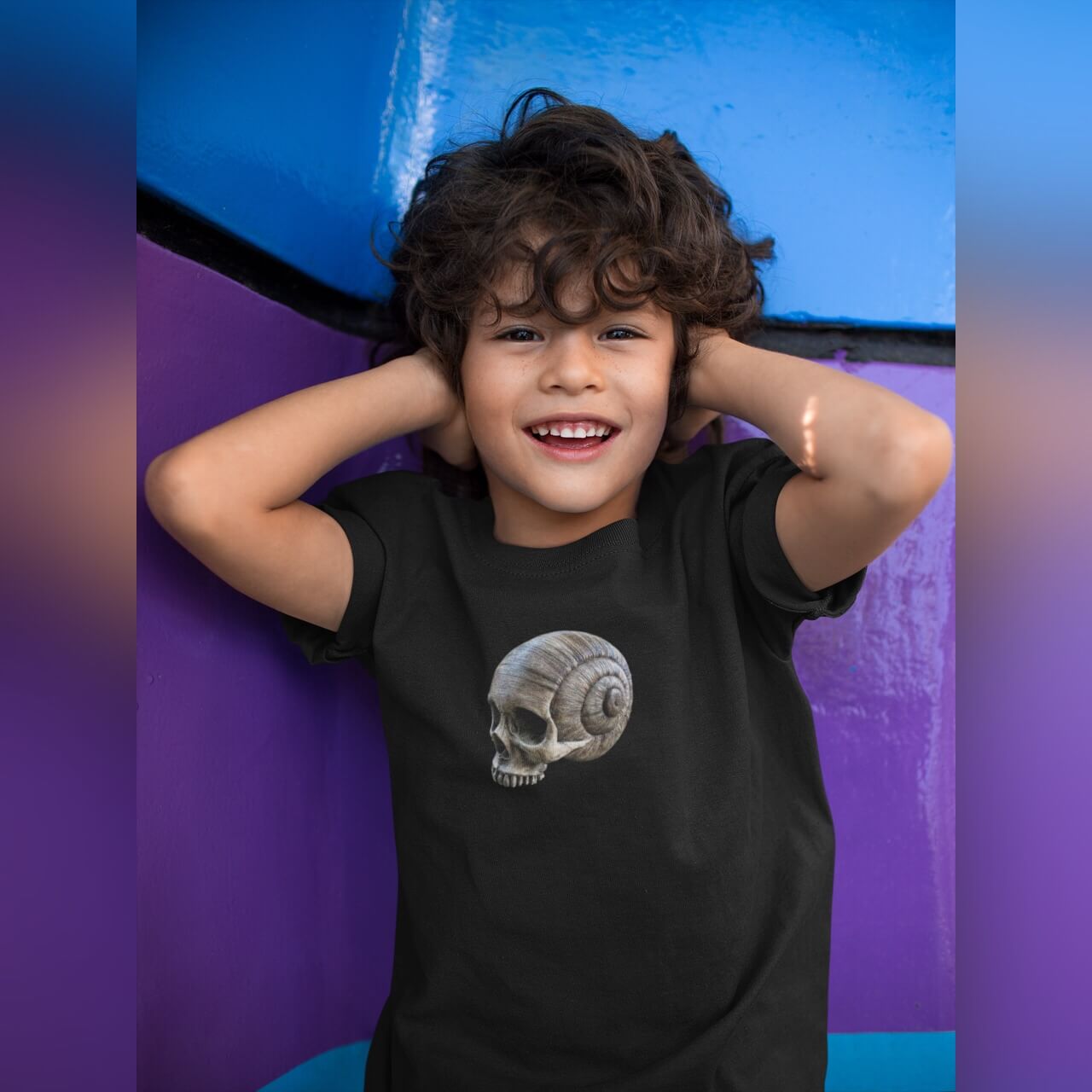 Young boy at play wearing short sleeve kid's spiral skull print t-shirt